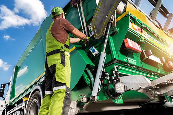 Refuse collection vehicles (RCVs) - collecting 1100 litre Wheelie Bins from Businesses